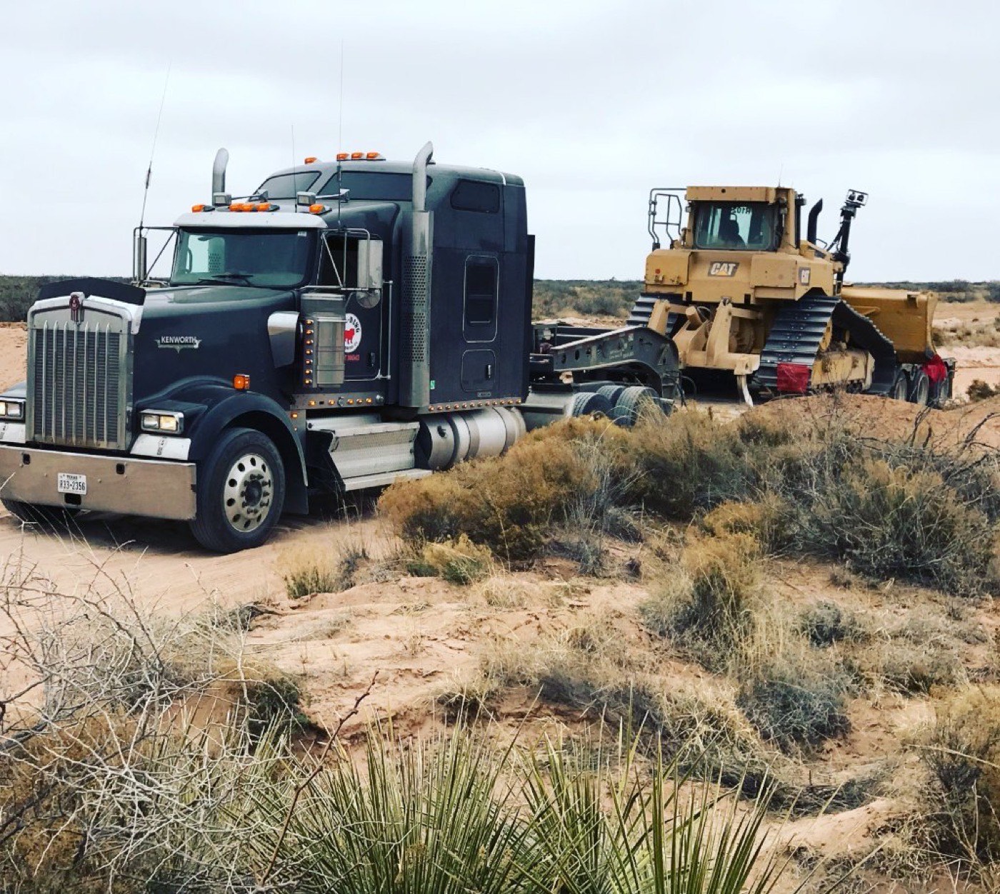 Kenworth heavy haul truck pulling a CAT dozer on a lowboy trailer
