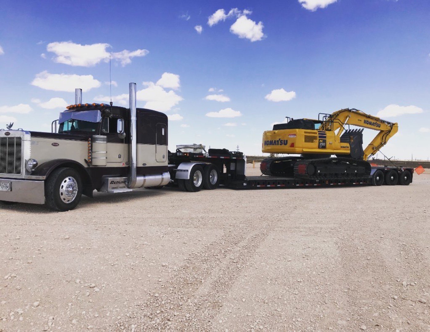 Peterbilt lowboy hauling a Komatsu excavator